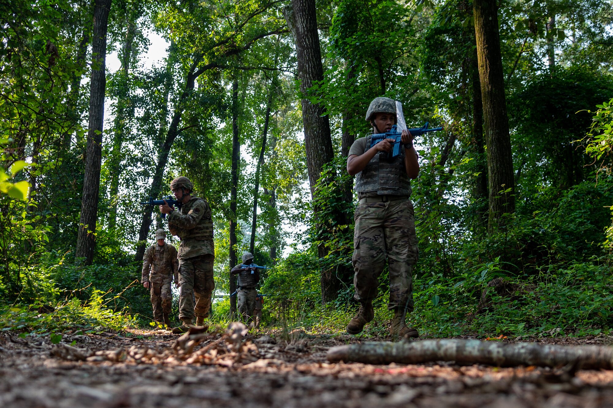 Airmen from the 4th Civil Engineer Squadron patrol the woods as part of the Prime Base Engineer Emergency Force, or Prime BEEF, program at Seymour Johnson Air Force Base, North Carolina, July 22, 2021. The Prime BEEF program gives Airmen a chance to complete all their required training in a three-day period. (U.S. Air Force photo by Airman 1st Class David Lynn)