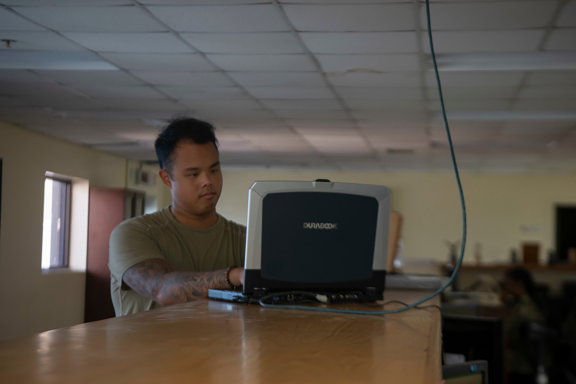 An Airman works on a computer to configure radar settings.