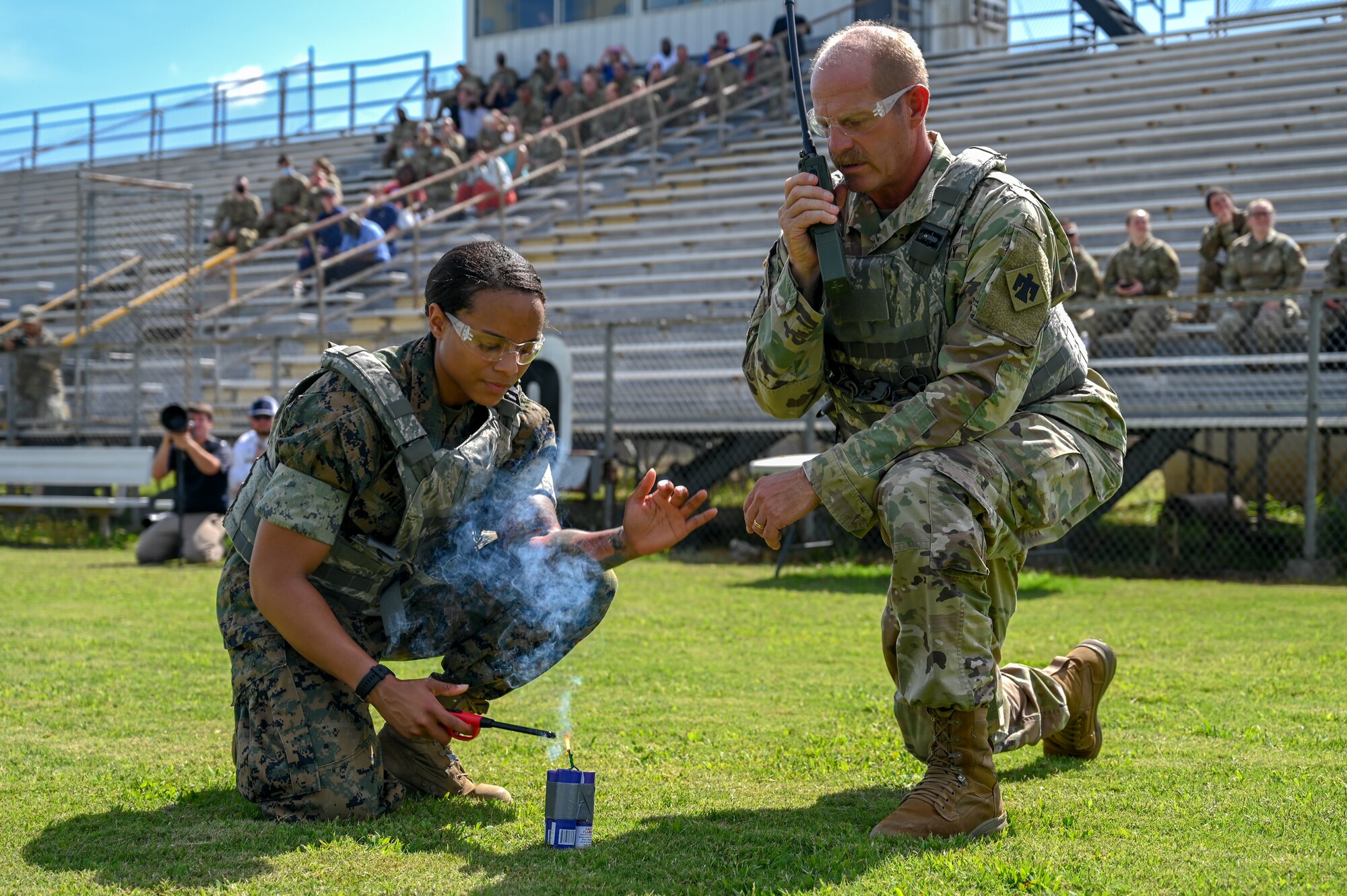 USN Petty Officer 1st Class Millaj Jallim, Lake Village, Arkansas site noncommissioned officer in charge, and U.S. Army 1st. Sgt. Richard Pindel, Command and Control 1st. Sgt, light a smoke signal so a medical helicopter can locate them during a mass-casualty exercise, July 15, 2021. The mass-casualty exercise showed how training such as 9-line medical evacuation, Tactical Combat Casualty Care and K9 Self Aid Buddy Care can be used together during medical emergencies. (U.S. Air National Guard photo by Airman Tyler Catanach)