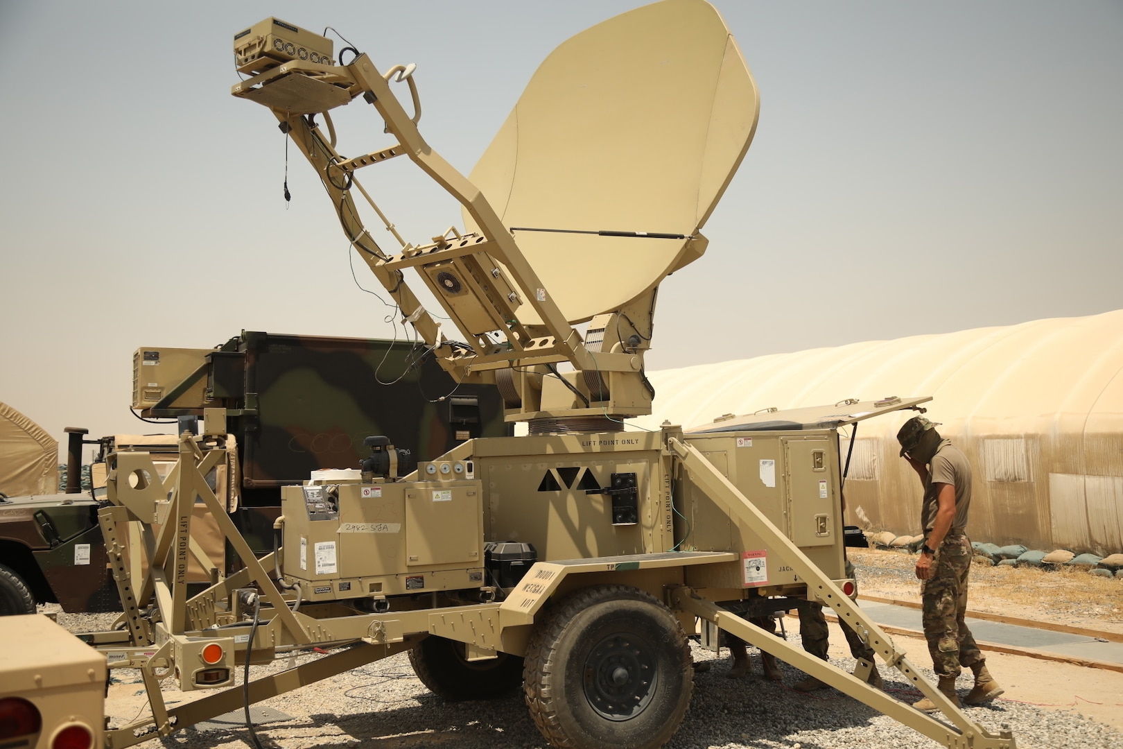 A soldier sets up a satellite.