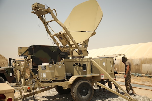 A soldier sets up a satellite.