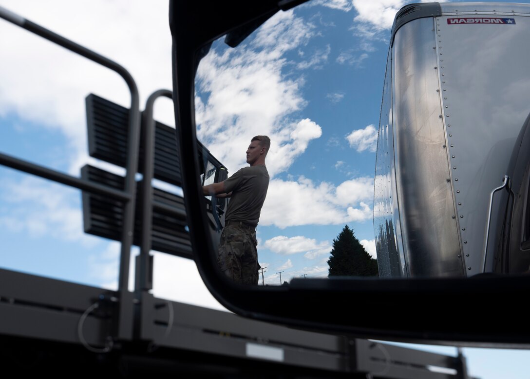U.S. Air Force Senior Airman Hayden Floyd, air freight journeyman with the 62nd Aerial Port Squadron, oversees an aircraft upload training before assisting in the simulation at Joint Base Lewis-McChord, Washington, July 21, 2021. Floyd, along with the other six Airmen on his team, will compete in the 2021 Pacific Air Forces (PACAF) Port Dawg Rodeo at Joint Base Pearl Harbor-Hickam, Hawaii, in August. (U.S. Air Force photo by Senior Airman Zoe Thacker)