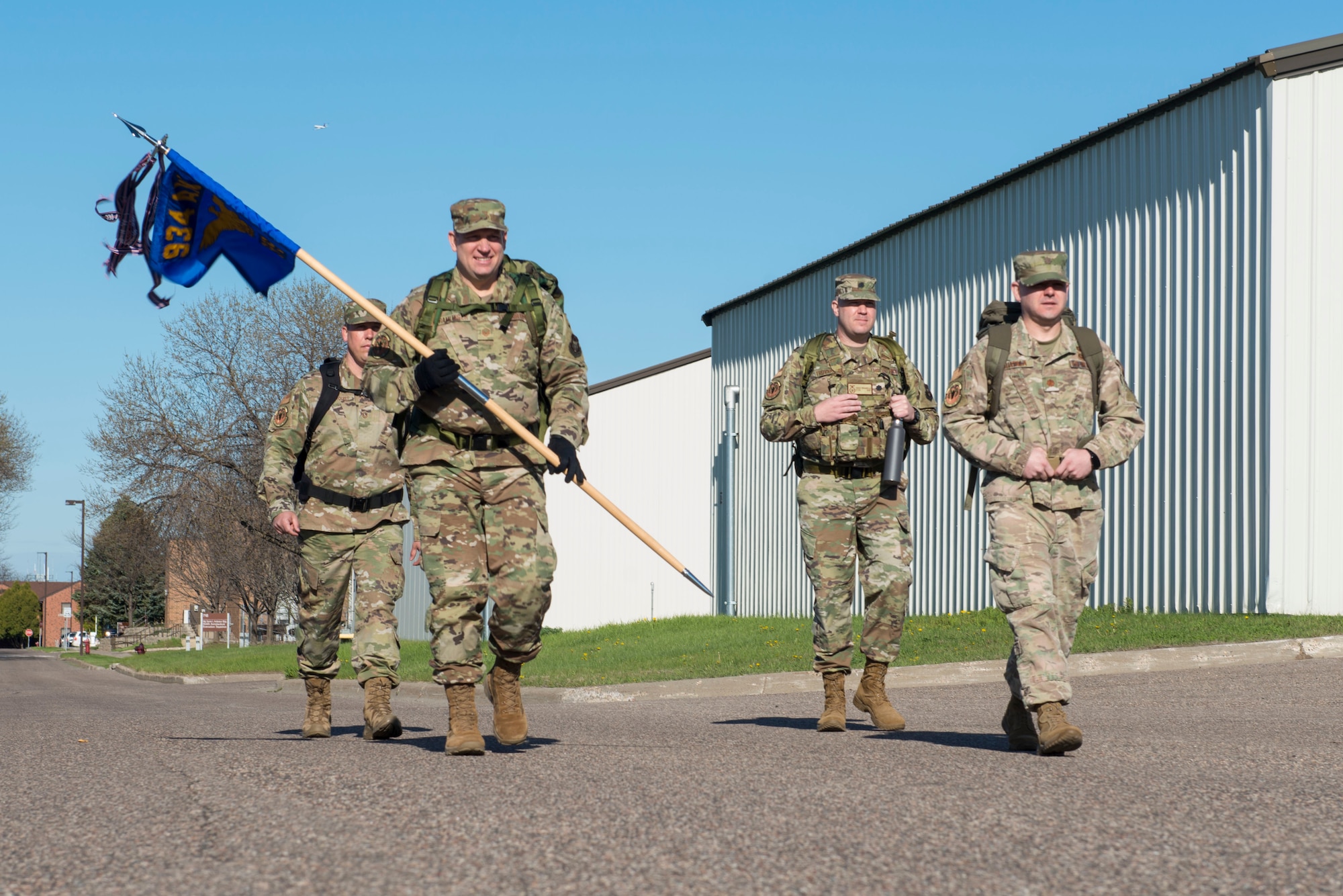 Master Sgt. Glen Kramlinger (front left), 934th Security Forces Squadron plans and programs manger, Maj. Ryan Buatala (front right), 934th Security Forces Squadron operations officer, Master Sgt. Kory Soderquist (back left), 934th Security Forces Squadron chief of training, and Lt. Col. Charles Trovarello (back right), 934th Security Forces Squadron commander, each carry 40-pound ruck sacks during a 4.5 mile ruck march in support of the Resolute Defender Ruck Challenge at Minneapolis-St. Paul Air Reserve Station, April 30, 2021. The intent for this 12 month challenge is to build and solidify resiliency, camaraderie, and communication. Currently, 40 Airmen and civilians, comprising 19 different teams, are taking part in the challenge. (Air Force photo by Chris Farley)
