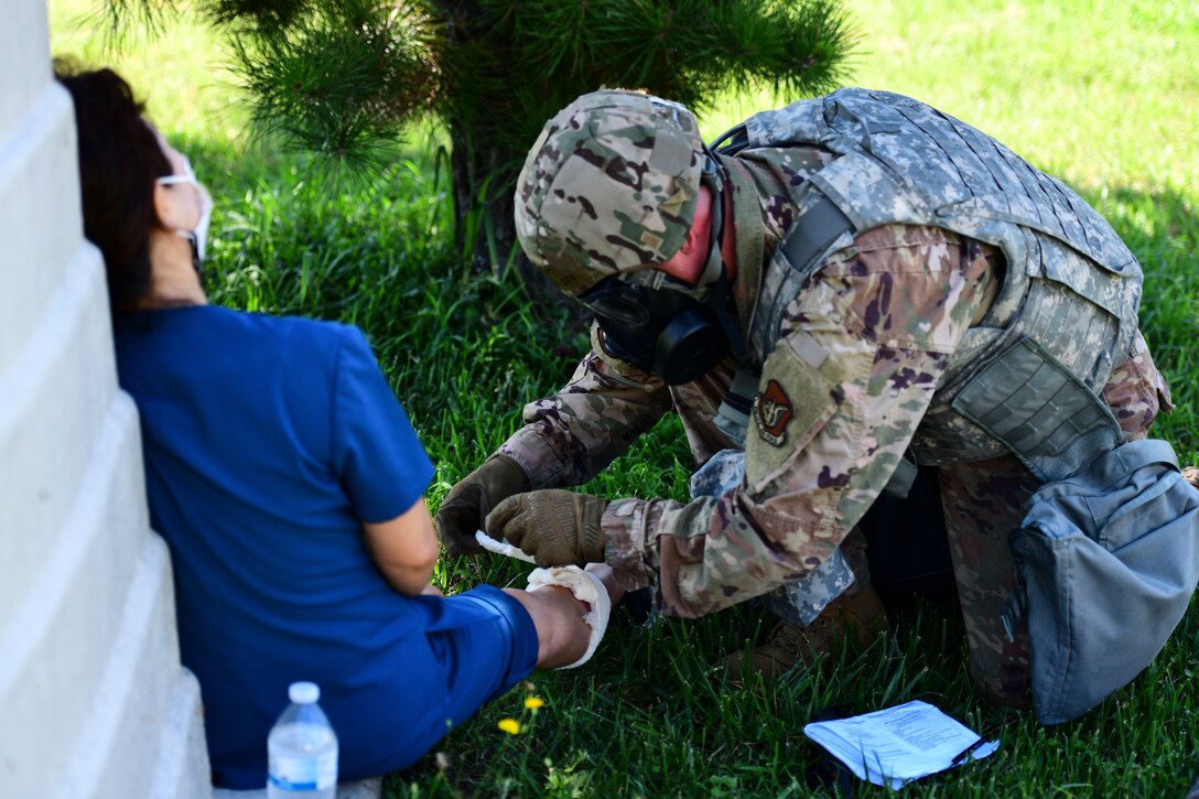 An Airman treats a simulated patient.