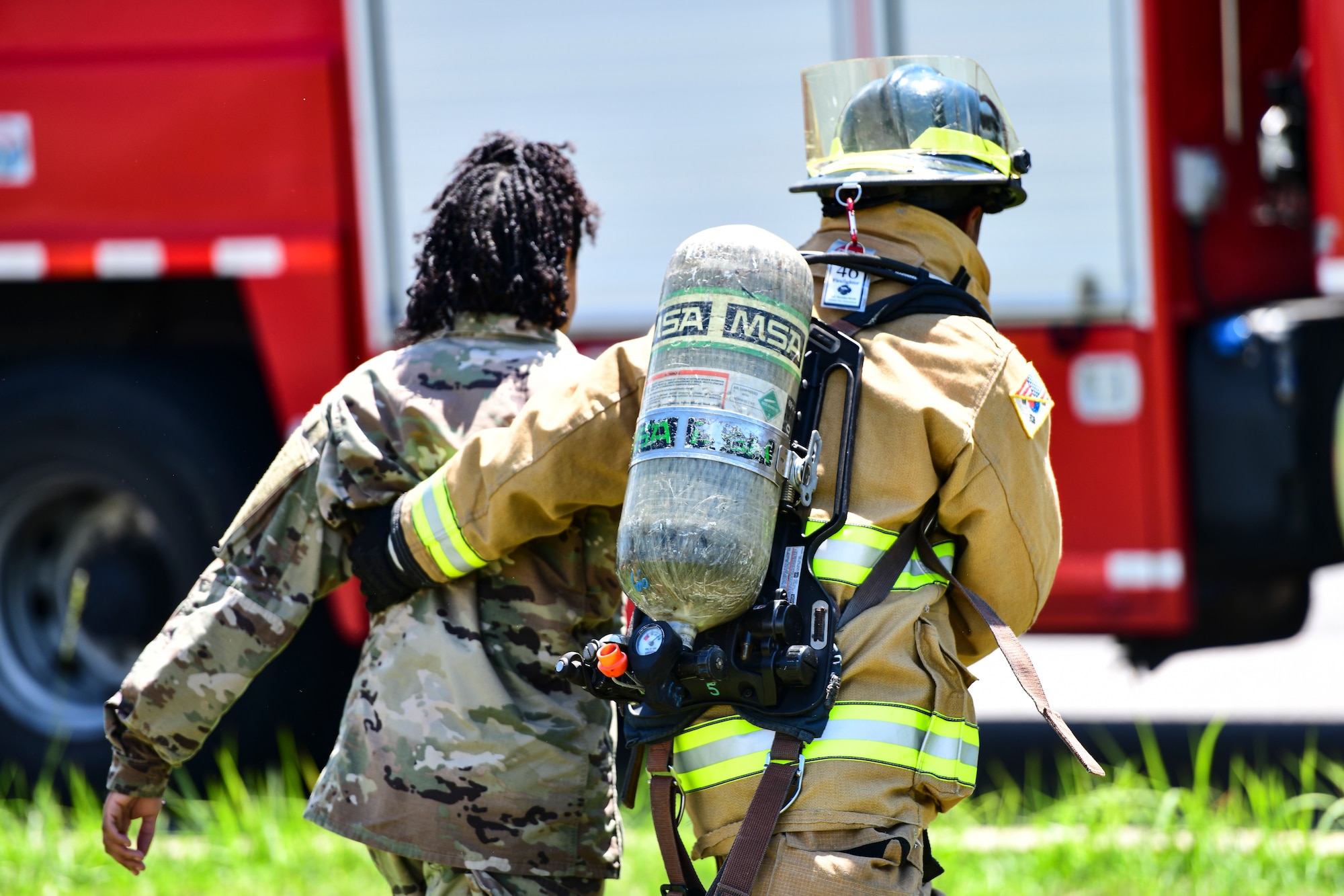 An Airman escorts a simulated patient.