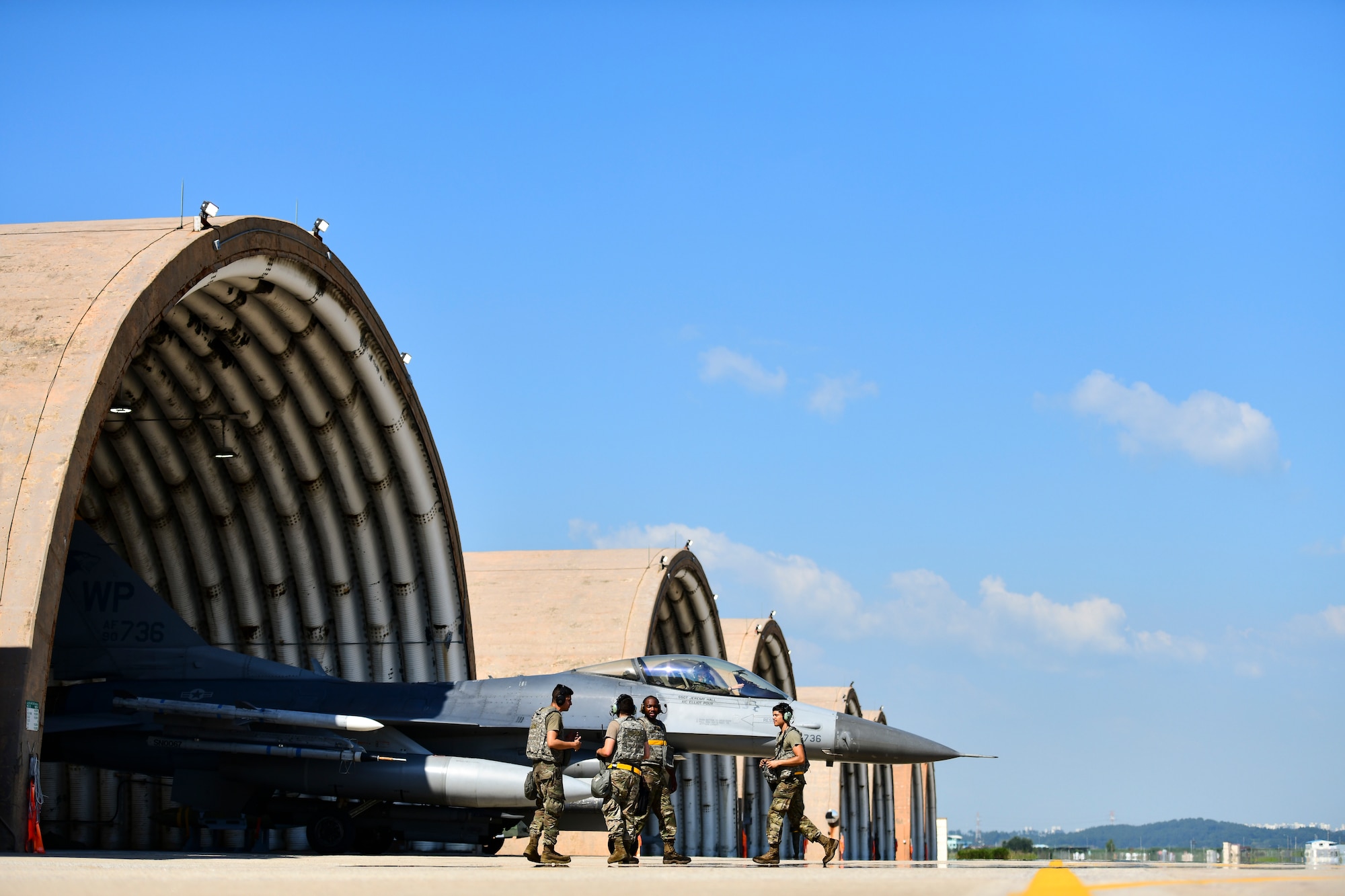 Maintainers communicate on the flightline.