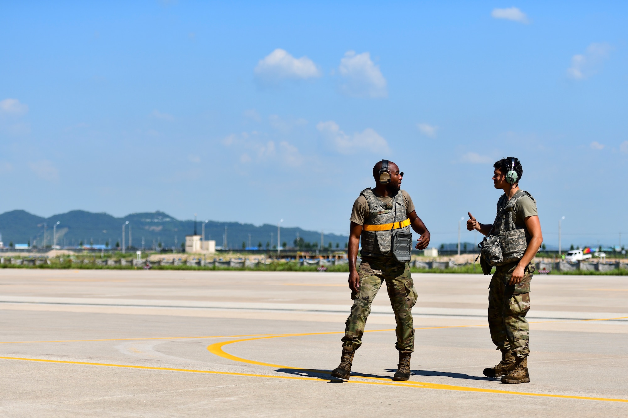 Maintainers speak on the flightline.