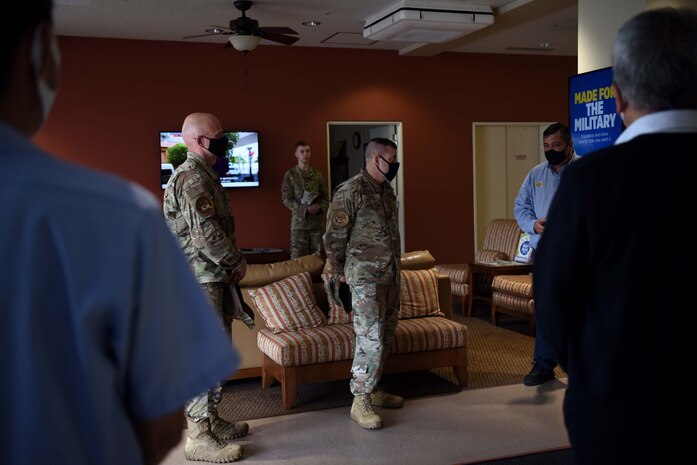Individuals speak inside buildings about improvements