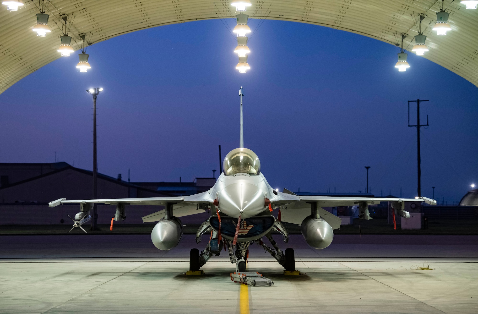 F-16 Fighting Falcon sits in a flow hangar.