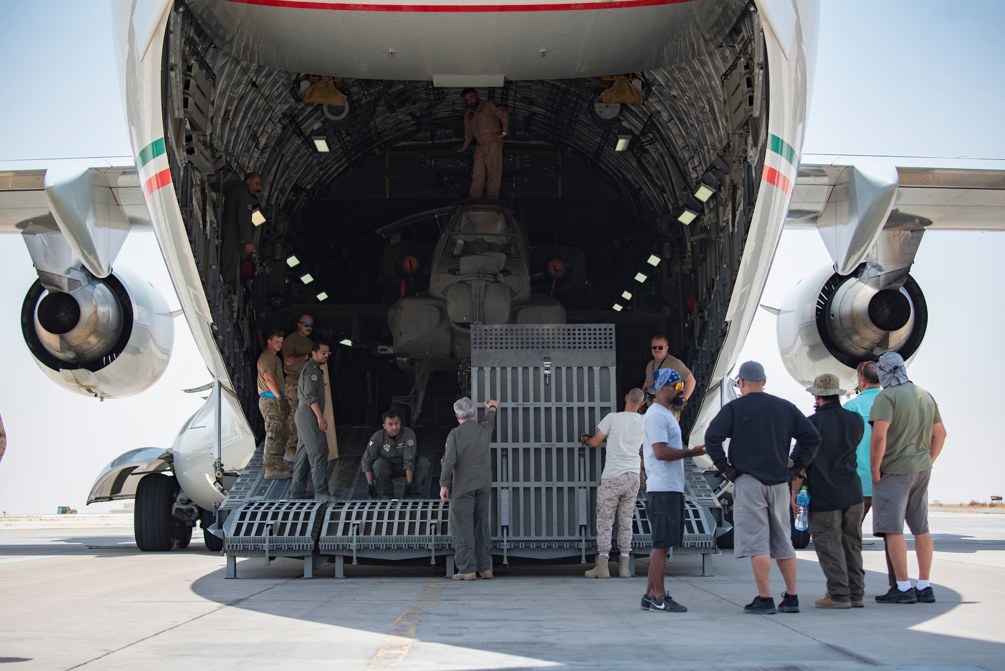 U.S. Airmen and members of the Kuwait Air Force load an AH-64E APACHE on a Kuwait Air Force C-17 Globemaster III at Ali Al Salem Air Base, Kuwait, July 26, 2021. One of the priorities of the 386th Air Expeditionary Wing is to foster enduring partnerships. These partnerships are built on mutual respect and critical to current and future missions. (U.S. Air Force Senior Airman Helena Owens)