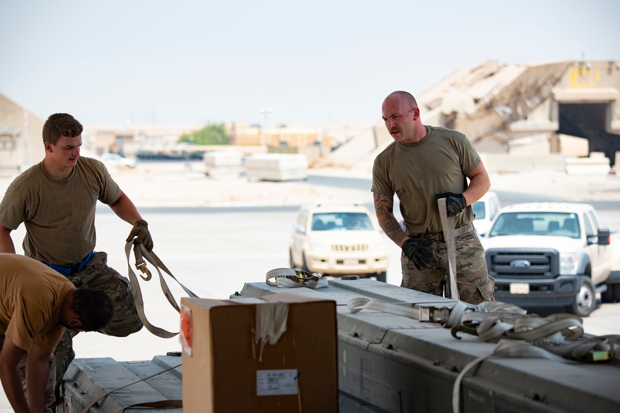 U.S. Air Force Senior Airman Colby Lash, (left) a ramp specialist assigned to the 386th Expeditionary Logistics Readiness Squadron and deployed from Joint Base McGuire-Dix-Lakehurst, New Jersey, and Senior Airman William Ford, (right) an aerial port expediter assigned the 386th Expeditionary Logistics Readiness Squadron and deployed from Travis AFB, California, prepare to load a case onto a Kuwait Air Force C-17 Globemaster III at Ali Al Salem Air Base, Kuwait, July 26, 2021. One of the priorities of the 386th Air Expeditionary Wing is to foster enduring partnerships. These partnerships are built on mutual respect and critical to current and future missions. (U.S. Air Force Senior Airman Helena Owens)