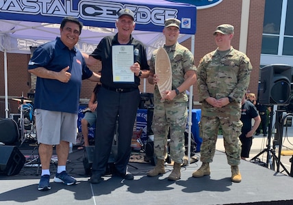 Virginia Army National Guard recruiters participate in Local Heroes Day July 17, 2021, in Virginia Beach, Virginia. Along with local first responders, the recruiters from the  accepted a proclamation and an engraved surfboard from Virginia Beach Mayor Bobby Dyer at the event. (Courtesy Photo)