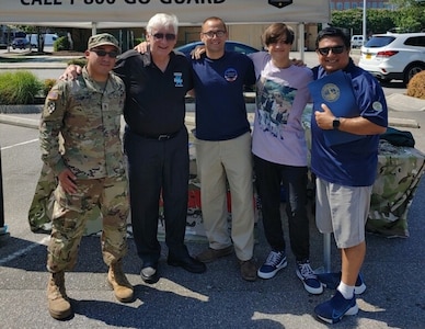 Virginia Army National Guard recruiters participate in Local Heroes Day July 17, 2021, in Virginia Beach, Virginia. Along with local first responders, the recruiters from the  accepted a proclamation and an engraved surfboard from Virginia Beach Mayor Bobby Dyer at the event. (Courtesy Photo)