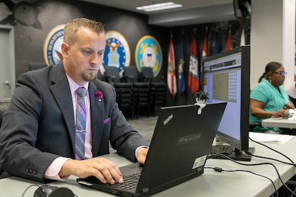 Scott Ferge, left, and Melanie Jackson, both U.S. Army Financial Management Command systems accountants, work during the Army’s mock fiscal yearend closeout at the Maj. Gen. Emmett J. Bean Federal Center July 19. Mock yearend is an exercise designed to prepare USAFMCOM and its partners for the fiscal yearend closeout and financial statement preparation at the start of October. (U.S. Army photo by Mark R. W. Orders-Woempner)