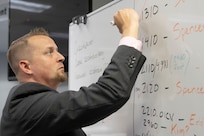 Scott Ferge, U.S. Army Financial Management Command systems accountant, checks off a list during the Army’s mock fiscal yearend closeout at the Maj. Gen. Emmett J. Bean Federal Center July 19. Mock yearend is an exercise designed to prepare USAFMCOM and its partners for the fiscal yearend closeout and financial statement preparation at the start of October. (U.S. Army photo by Mark R. W. Orders-Woempner)