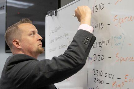 Scott Ferge, U.S. Army Financial Management Command systems accountant, checks off a list during the Army’s mock fiscal yearend closeout at the Maj. Gen. Emmett J. Bean Federal Center July 19. Mock yearend is an exercise designed to prepare USAFMCOM and its partners for the fiscal yearend closeout and financial statement preparation at the start of October. (U.S. Army photo by Mark R. W. Orders-Woempner)