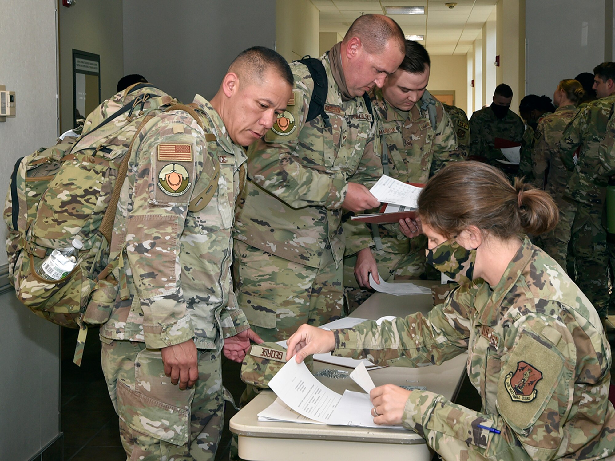 ALPENA, Mich.— Members of the 127th Security Forces Squadron, Selfridge Air National Guard Base, Michigan, check in with leadership prior to inprocessing at Alpena Combat Readiness Training Center here on July 27, 2021. The defenders arrived to participate in Exercise Spartan, a two weeks long exercise meant to demonstrate the unit’s capability to operate in a contested, degraded and operationally-limited environment, against a near-peer adversary.