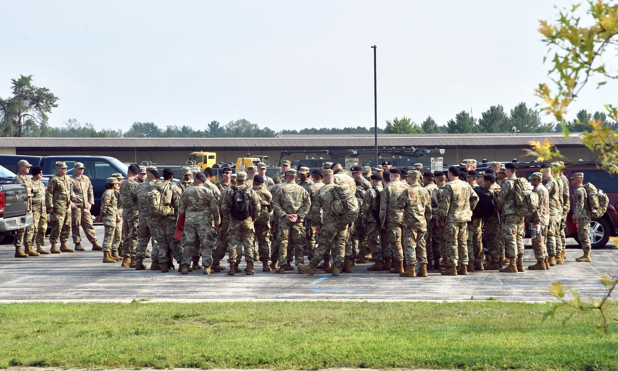ALPENA, Mich.— Members of the 127th Security Forces Squadron, Selfridge Air National Guard Base, Michigan, check in with leadership prior to inprocessing at Alpena Combat Readiness Training Center here on July 27, 2021. The defenders arrived to participate in Exercise Spartan, a two weeks long exercise meant to demonstrate the unit’s capability to operate in a contested, degraded and operationally-limited environment, against a near-peer adversary.