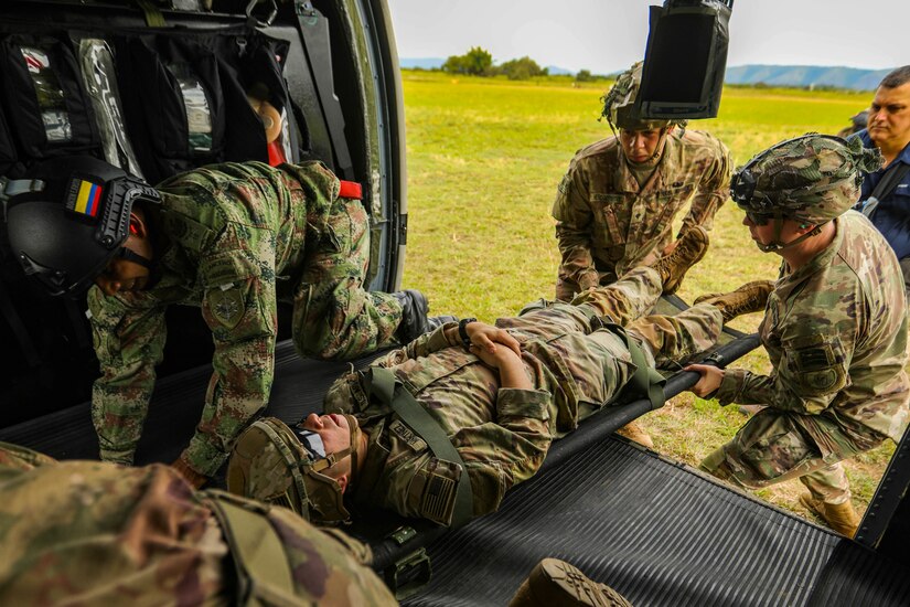 U.S. Army 82nd Airborne Division medics and a Colombian army combat medic conduct medical evacuation rehearsals in preparation for a combined airborne exercise July 24, 2021, at Tolemaida Air Base, Colombia. The U.aS. Army and Colombian military conducted a Dynamic Force Employment airborne exercise, also known as Exercise Hidra II, involving jungle and water survival training, multiple airborne jumps and a field training exercise. (U.S. Army photo by Pfc. Joshua Taeckens)