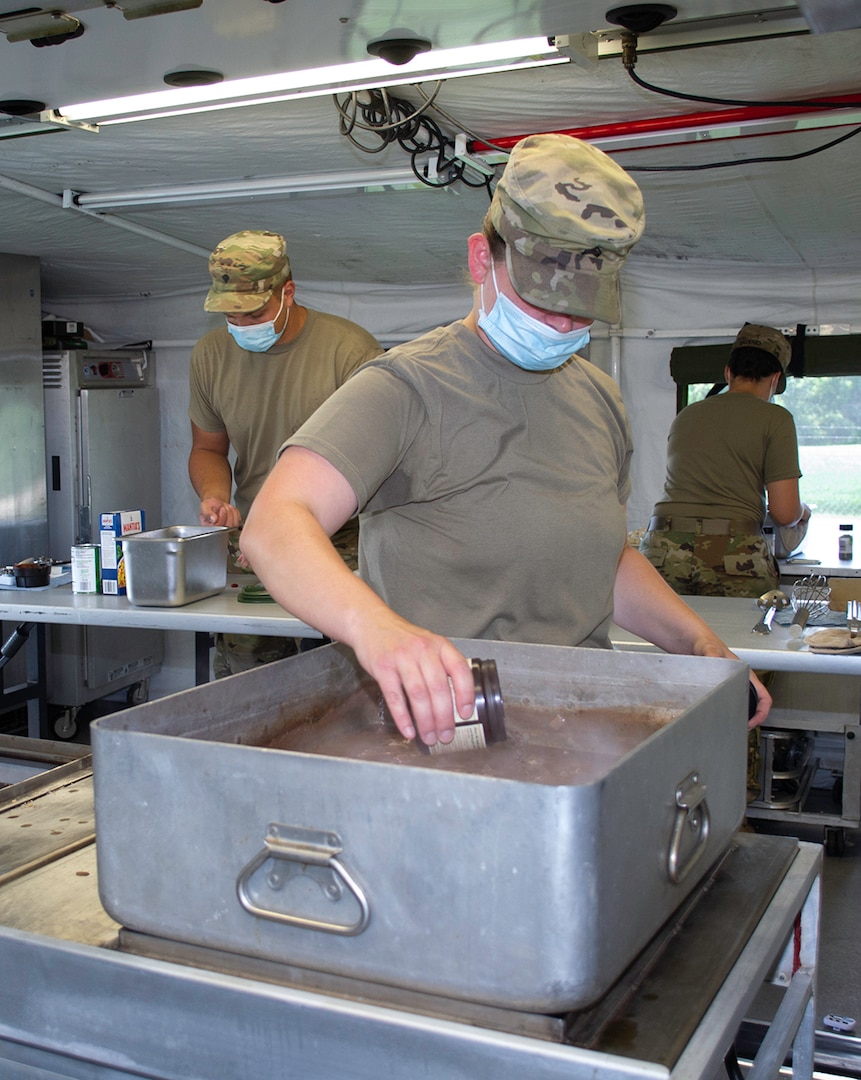 Sgt. Danielle Ash, of Carlinville, Illinois, a food service specialist assigned to Company D, 634th Brigade Support Battalion, based in Galva, Illinois, adds seasonings to the braised beef and noodles prepared during the Region IV Phillip A. Connelly Award competition Aug. 4, 2020 at Marseilles Training Center, Marseilles, Illinois.