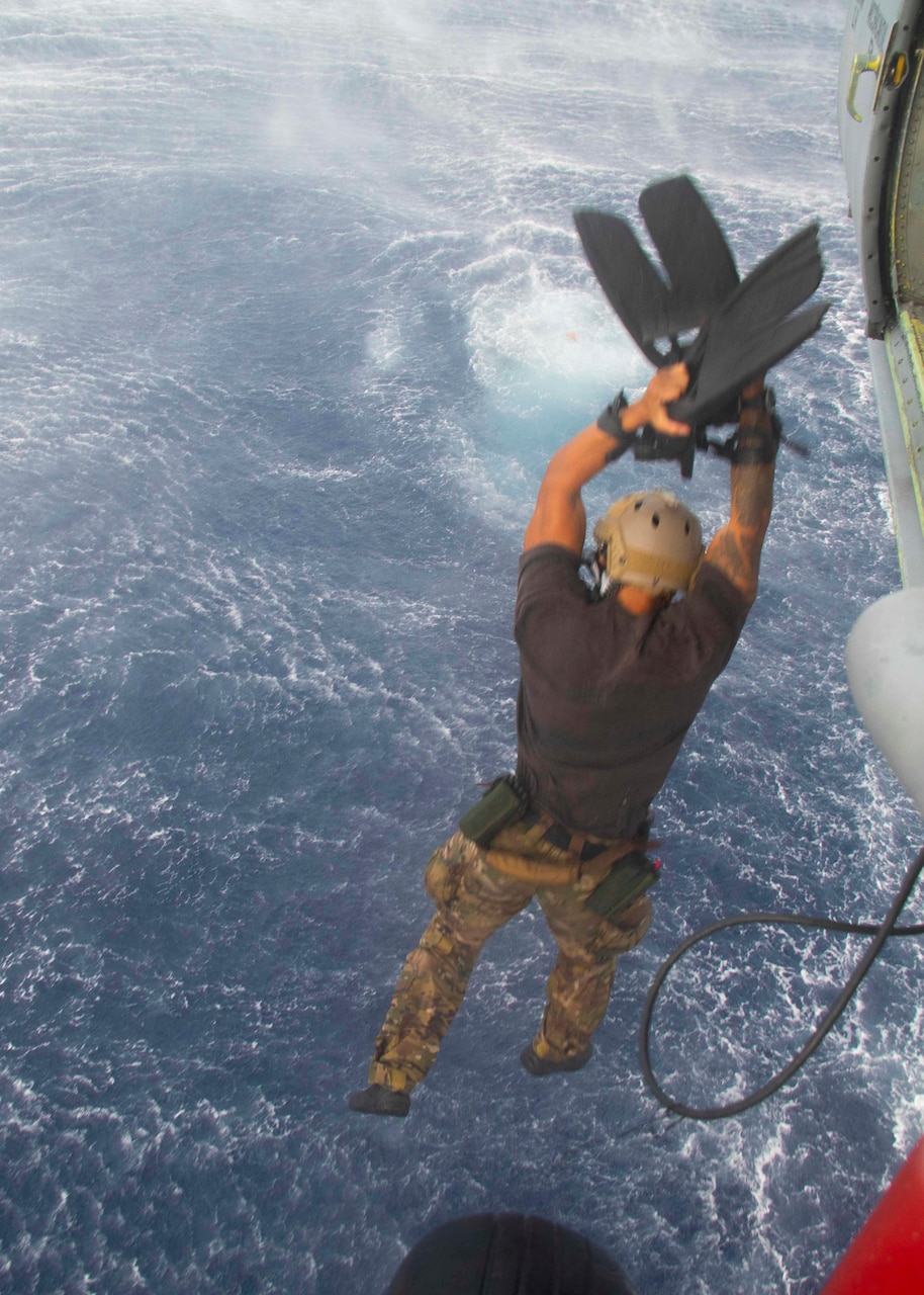 SOUTH CHINA SEA (July 7, 2021) Personnel assigned to Explosive Ordnance Disposal Mobile Unit 5 (EODMU 5) and Helicopter Sea Combat Squadron 21 (HSC 21), currently embarked on the Independence-variant littoral combat ship USS Tulsa (LCS 16) conduct flight operations while on deployment, in the South China Sea July 7. Tulsa, part of Destroyer Squadron Seven, is on a rotational deployment, operating in the U.S. 7th Fleet area of operations to enhance interoperability with partners and serve as a ready-response force in support of a free and open Indo-Pacific region. (U.S. Navy photo by Naval Air Crewman Helicopter 2nd Class Connor Clark)