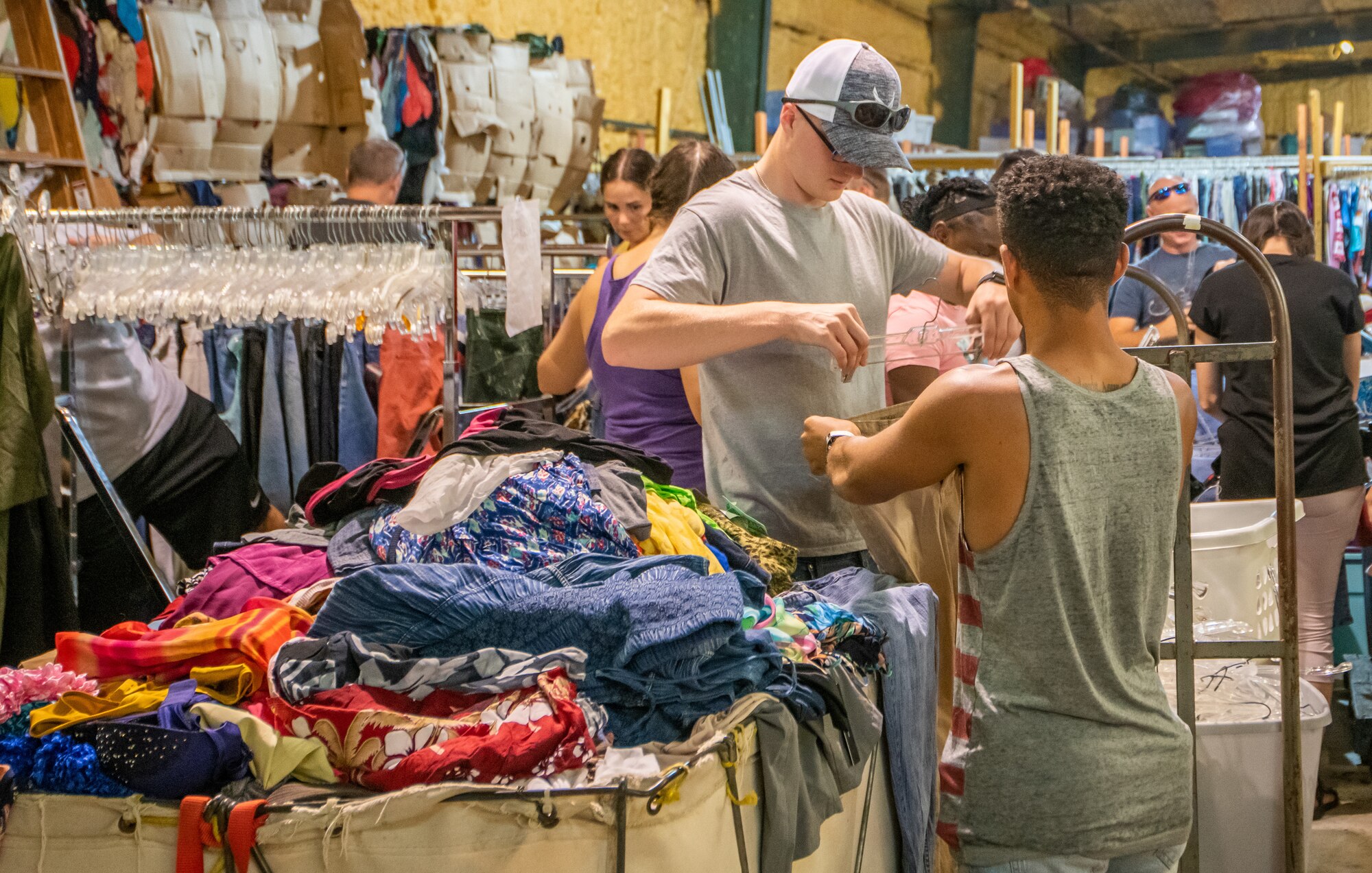 Air Force reservists from the 419th Fighter Wing organize and hang clothes July 22, 2021 at Hurlburt Field, Florida, for a service project as part of their two-week annual tour. The project was set up to assist the Salvation Army in Fort Walton Beach, Florida, sorting through the mounting pile of donations after their storefront was destroyed due to Hurricane Sally in 2019.