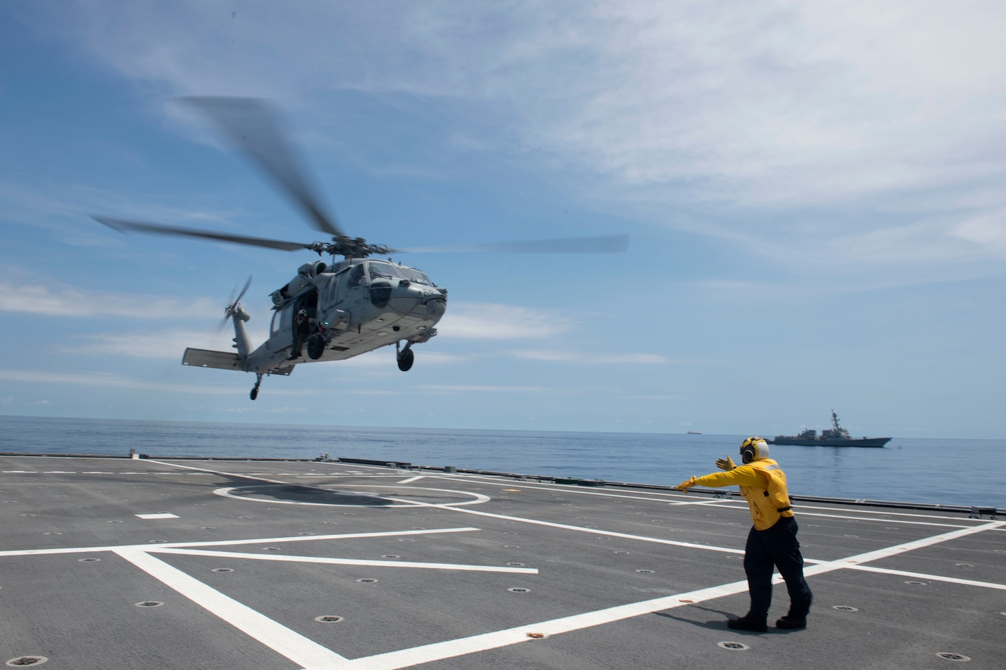 SOUTH CHINA SEA (July 9, 2021) Sailors assigned to the independence-variant littoral combat ship USS Tulsa (LCS 16) and Helicopter Sea Combat Squadron 21 (HSC 21) conduct flight operations while sailing with the Arleigh Burke-class guided missile destroyer USS Kidd (DDG 100), July 9. Tulsa, part of Destroyer Squadron Seven, is on a rotational deployment, operating in the U.S. 7th Fleet area of operations to enhance interoperability with partners and serve as a ready-response force in support of a free and open Indo-Pacific region. (U.S. Navy photo by Mass Communication Specialist 3rd Class Chase Stephens)