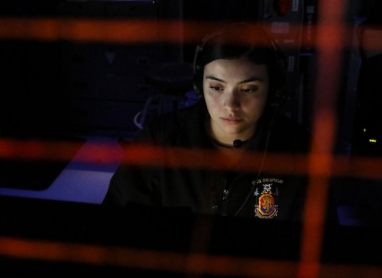 Operations Specialist 3rd Class Brianna Vasquez-Ragan, from Phoenix, monitors surface contacts from the combat information center aboard Arleigh Burke-class guided-missile destroyer USS Benfold (DDG 65) as the ship transits the Taiwan Strait.