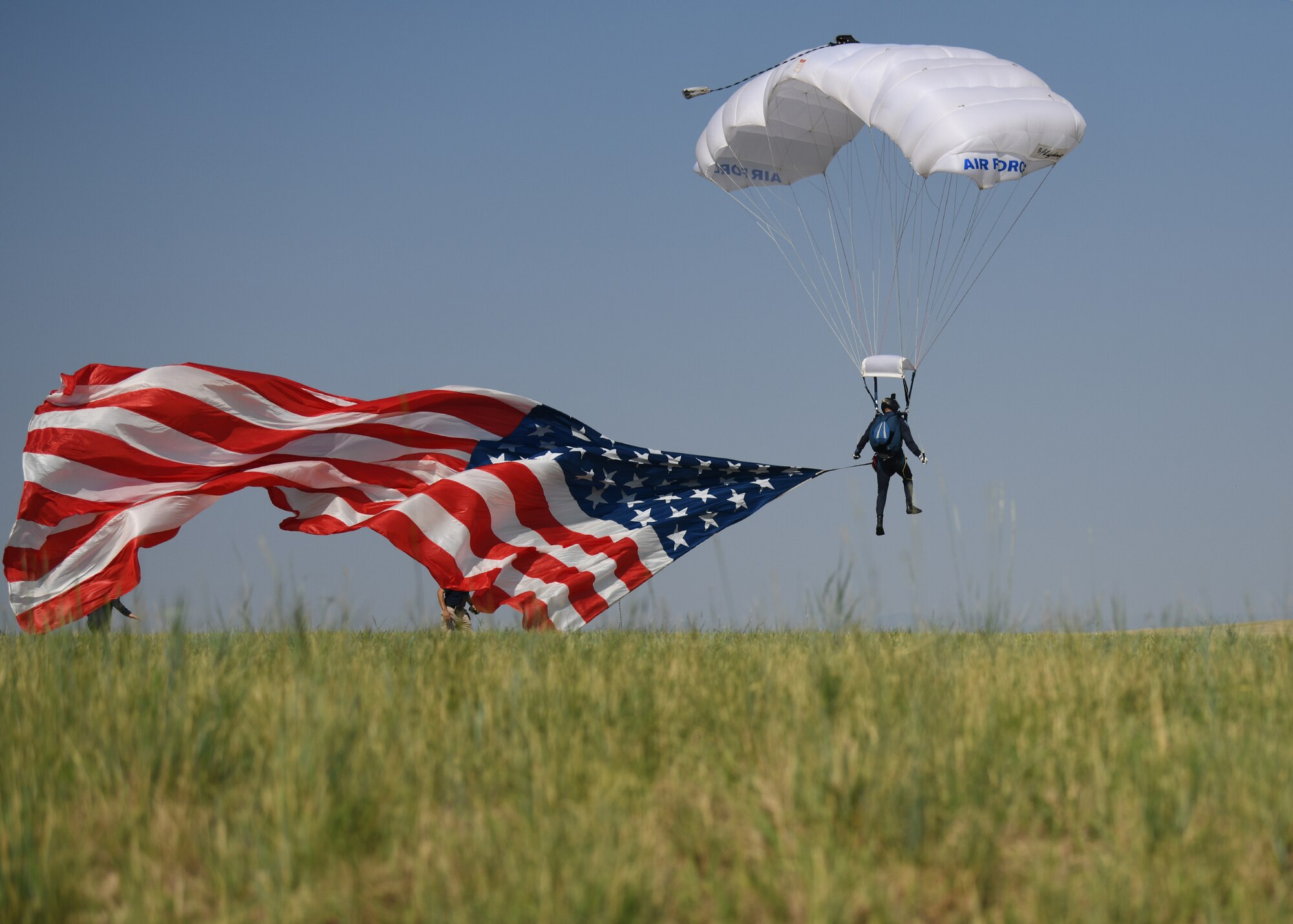 A skydiver with Wings of Blue, the U.S. Air Force Academy parachute demonstration team, descends to earth during the Wings over Warren air show July 28, 2021 at F. E. Warren Air Force Base, Wyoming. Wings over Warren is an annual air show scheduled in conjuction with Cheyenne Frontier Days. (U. S. Air Force photo by Airman 1st Class Darius Frazier)