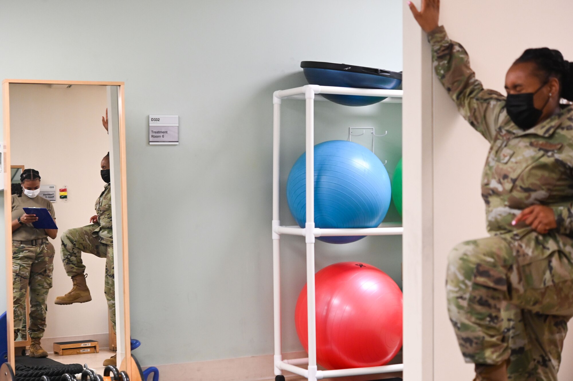 U.S. Air Force Senior Airman Gabrielle Rose, 375th Operational Medical Readiness Squadron physical therapy technician helps Senior Airman Jaisha Walker, 932nd Air Wing career development personnelist, with a strengthening exercise at the 375th Medical Group Physical Therapy Clinic at Scott Air Force Base, Illinois, July 27, 2021. Rose conducted a standing march exercise to help with lower back and quadricep strengthening after an injury. (U.S. Air Force photo by Staff Sgt. Dalton Williams)