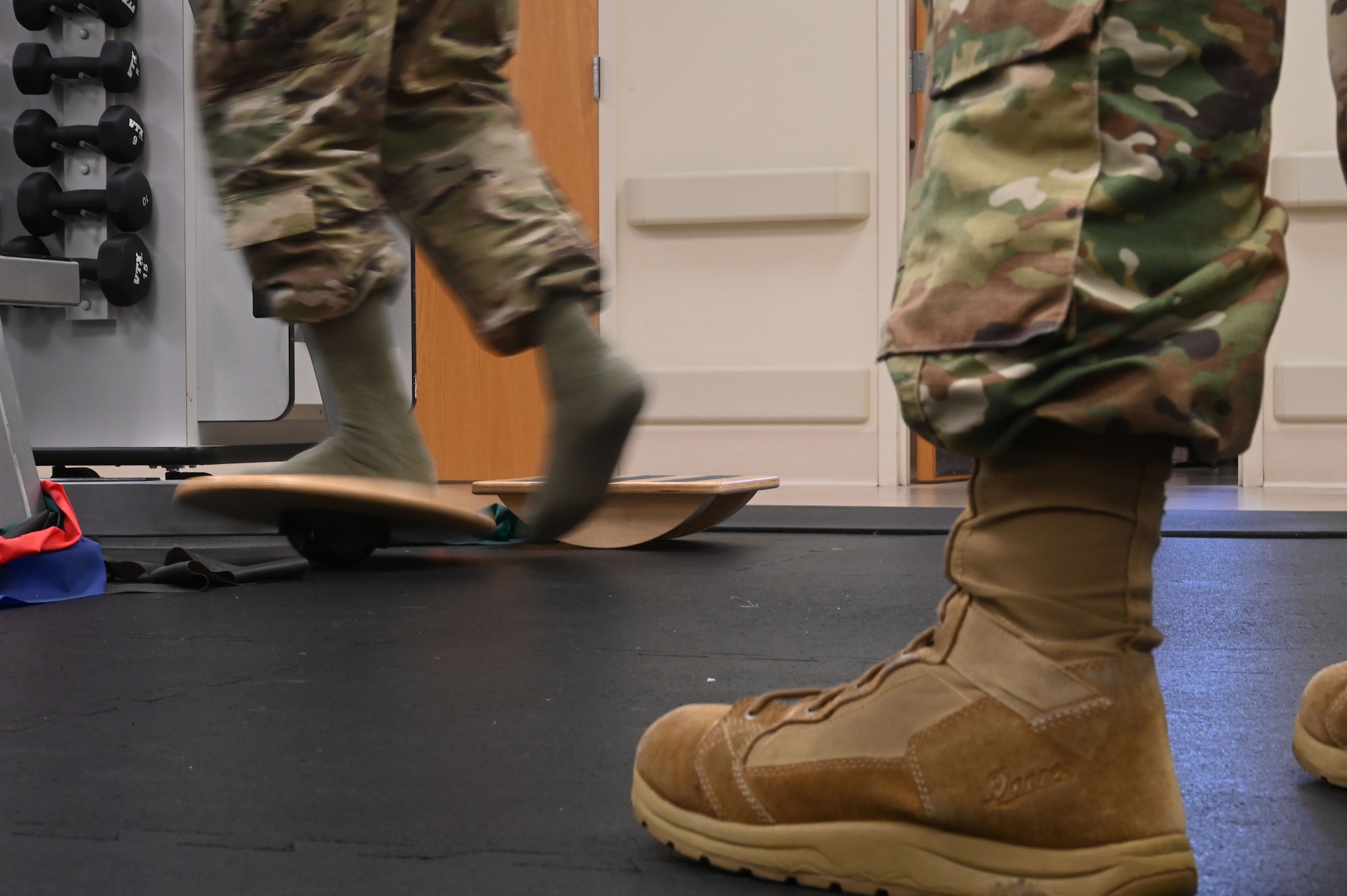 U.S. Air Force Senior Airman Daemon Rawlins, 375th Operational Medical Readiness Squadron physical therapy technician works on a patient’s ankle mobility during a physical therapy exercise at the 375th Medical Group Physical Therapy Clinic at Scott Air Force Base, Illinois, July 27, 2021. Standing on a rotating disk and moving around both clockwise and counterclockwise works the range of motion in a patient’s ankle. (U.S. Air Force photo by Staff Sgt. Dalton Williams)