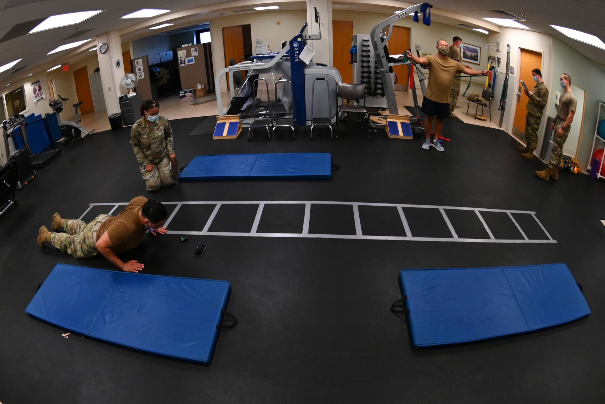 Physical therapy technicians from the 375th Operational Medical Readiness Squadron work with patients on their physical treatment plan at the Physical Therapy Clinic at Scott Air Force Base, Illinois, July 27, 2021. Each patient has an individual treatment plan specifically made for them to follow after an initial assessment by a physical therapist to measure their initial physical baseline. (U.S. Air Force photo by Staff Sgt. Dalton Williams)