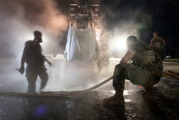 Airmen assigned to the 8th Civil Engineer Squadron fill a crater with water and concrete during a Rapid Airfield Damage Repair training at Kunsan Air Base, Republic of Korea