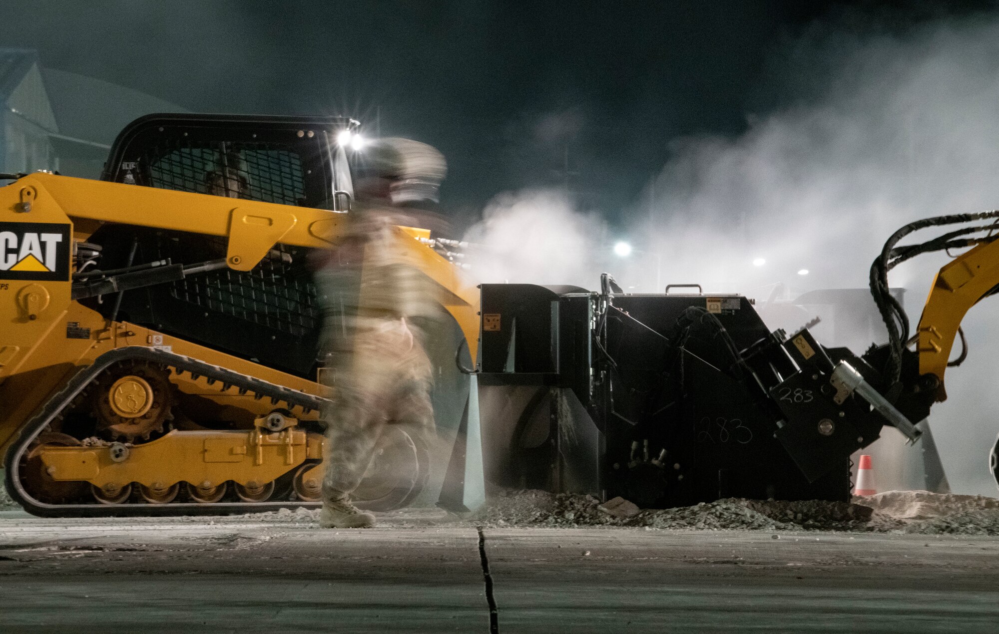 An Airman assigned to the 8th Civil Engineer Squadron shovels dirt and concrete during Rapid Airfield Damage Repair training at Kunsan Air Base, Republic of Korea