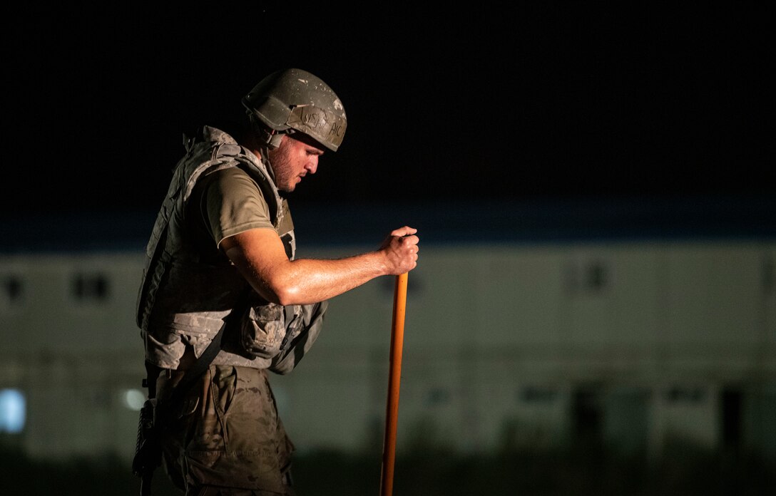 An Airman assigned to the 8th Civil Engineer Squadron shovels dirt and concrete during Rapid Airfield Damage Repair training at Kunsan Air Base, Republic of Korea