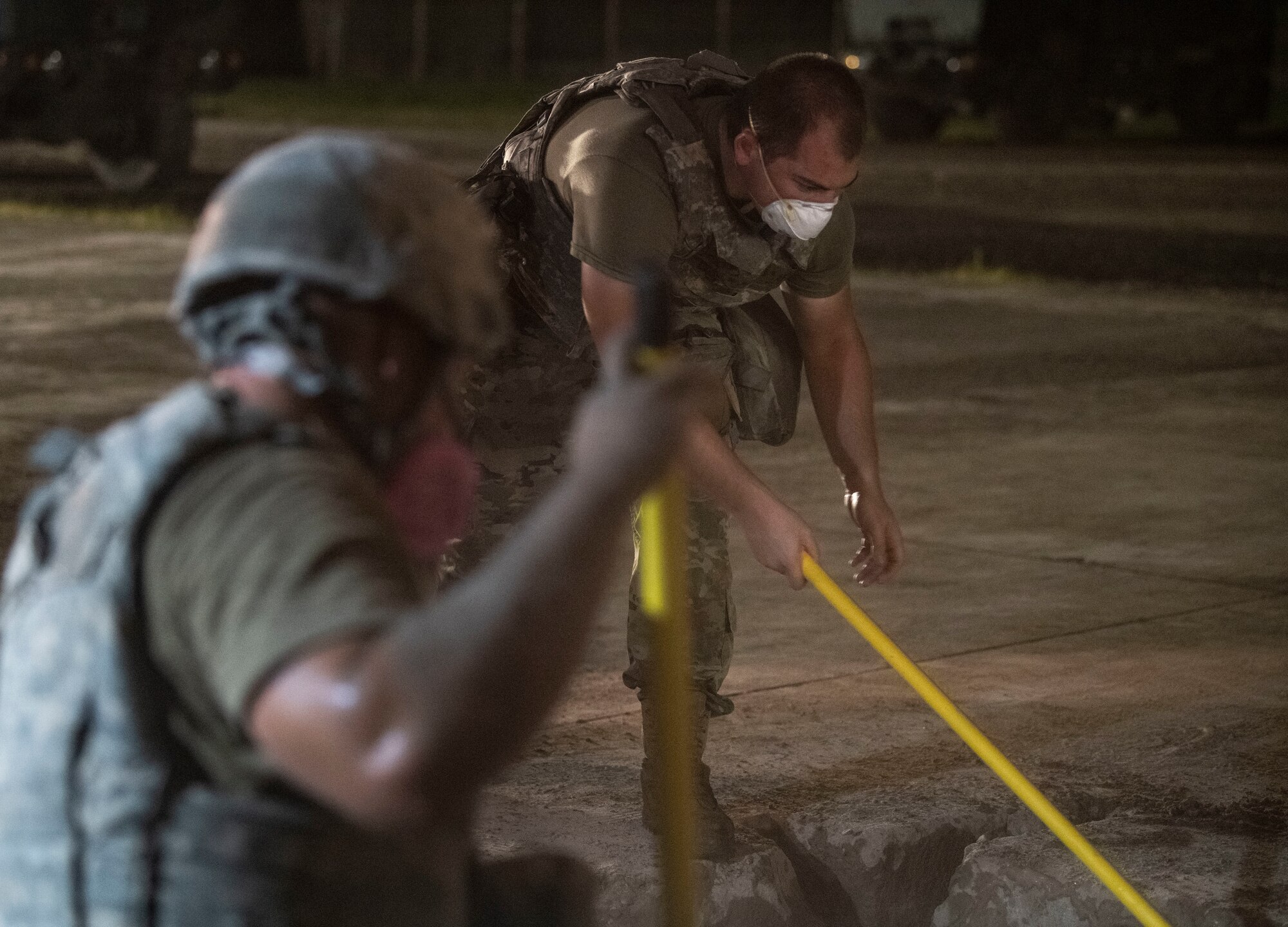 Airmen assigned to the 8th Civil Engineer Squadron fill a crater with water and concrete during a Rapid Airfield Damage Repair training at Kunsan Air Base, Republic of Korea
