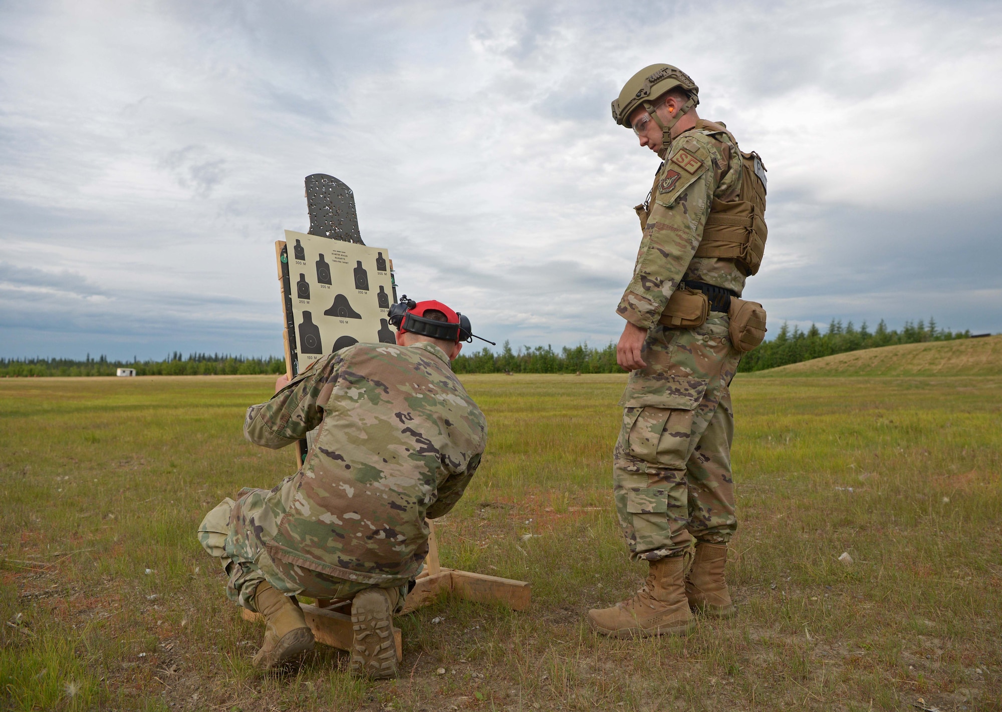 Airmen from the 354th Security Forces Squadron check a target during a new Security Forces Qualification Course on Eielson Air Force Base, Alaska, July 14, 2021. Throughout the course, Eielson Defenders and Combat Arms instructors will be giving feedback directly to the U.S. Air Force Security Forces Center at Lackland Air Force Base, Texas. (U.S. Air Force photo by Senior Airman Beaux Hebert)