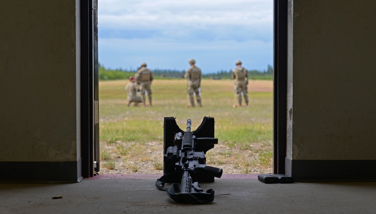 Airmen from the 354th Security Forces Squadron check their targets during a new Security Forces Qualification Course on Eielson Air Force Base, Alaska, July 14, 2021. The new course is designed to train and test Defenders, rookies and veterans, how to properly and accurately use their firearms in the line of duty. (U.S. Air Force photo by Senior Airman Beaux Hebert)