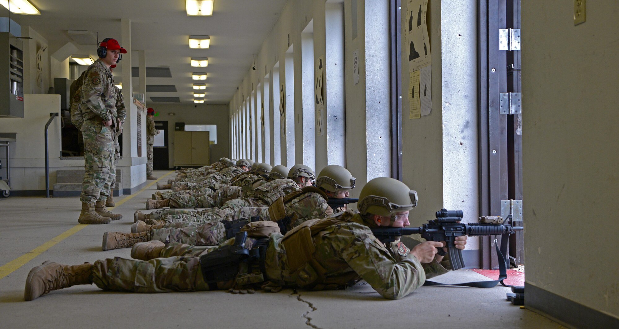Airmen from the 354th Security Forces Squadron (SFS) fire M4 carbines during a new Security Forces Qualification Course on Eielson Air Force Base, Alaska, July 14, 2021. The 354th SFS Combat Arms instructors have been tasked with training this new course to Defenders on Eielson. (U.S. Air Force photo by Senior Airman Beaux Hebert)