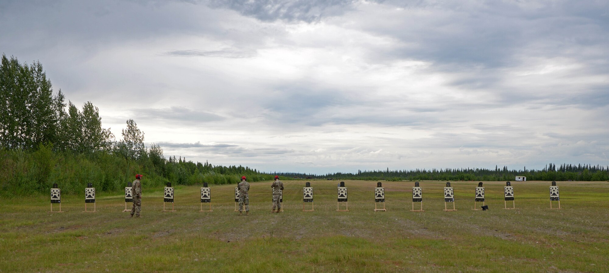 Airmen from the 354th Security Forces Combat Arms examine and score targets during a new Security Forces Qualification Course on Eielson Air Force Base, Alaska, July 14, 2021. Eielson is one of 15 installations testing the new weapons qualification course. (U.S. Air Force photo by Senior Airman Beaux Hebert)