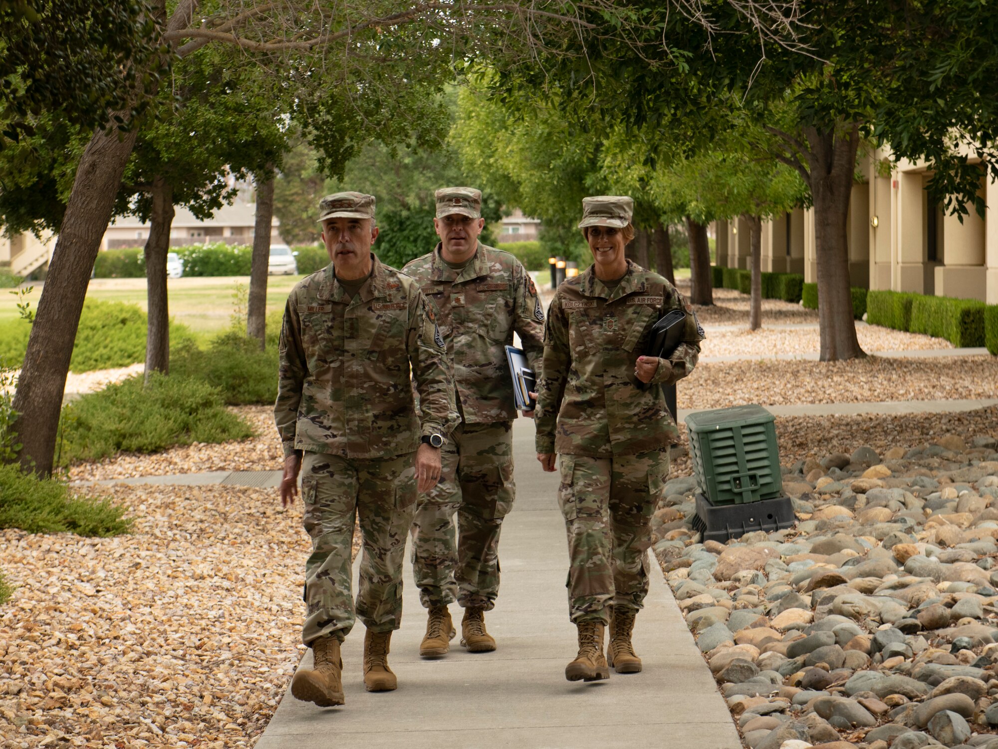 U.S. Air Force Lt. Gen. Robert Miller, Air Force and Space Force Surgeon General, left, along with his executive assistant, Maj. Richard Smith, center, and Chief Master Sgt. Dawn Kolczynski, medical enlisted force and enlisted corps chief, walk outside of base lodging July 27, 2021, at Travis Air Force Base, California.