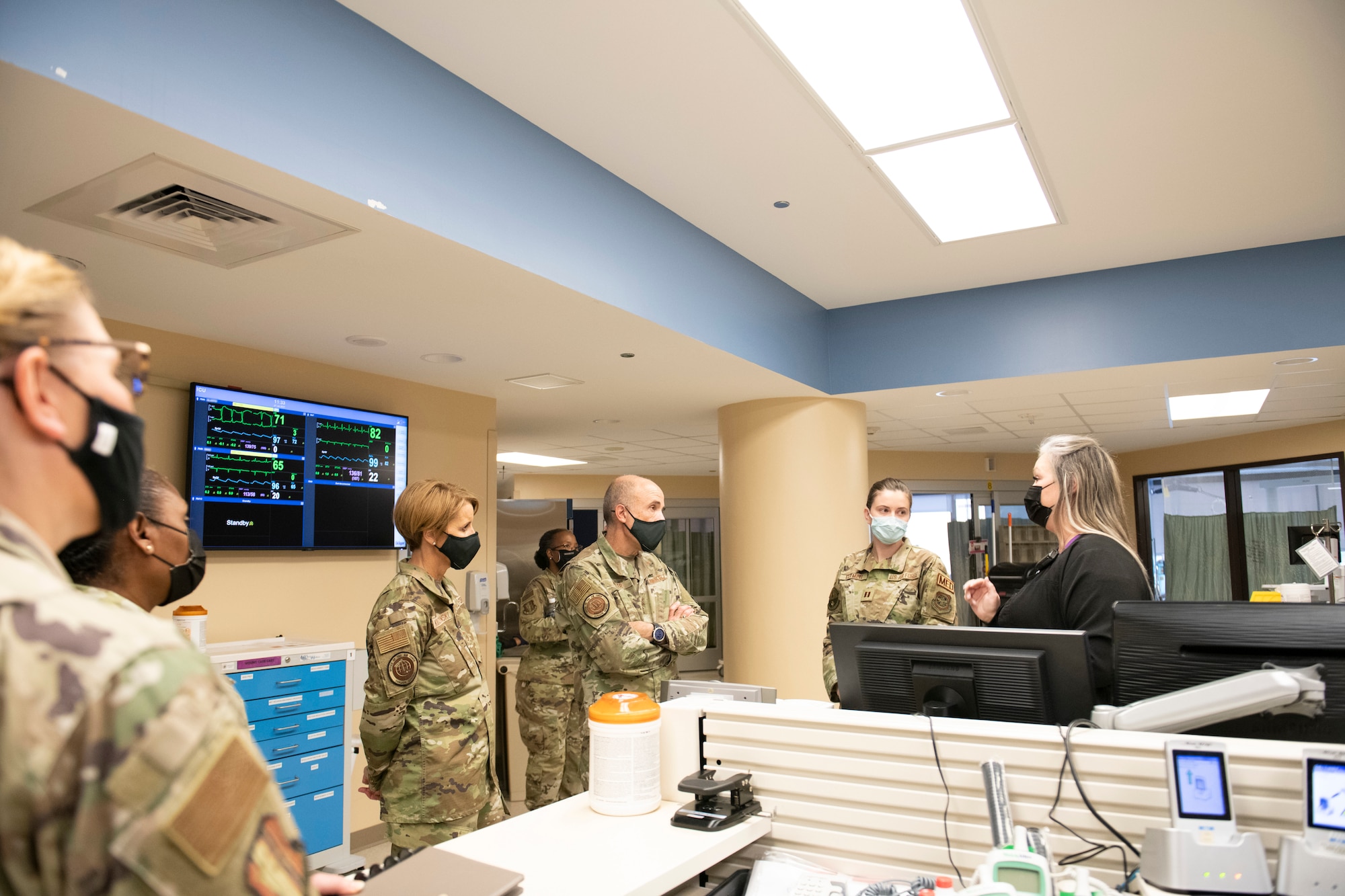 Jennifer Thompson, 60th Inpatient Squadron critical care nurse, right, briefs U.S. Air Force Lt. Gen. Robert Miller, Air Force and Space Force Surgeon General, center, on the main floor of the intensive care unit at Travis Air Force Base, California, July 27, 2021.
