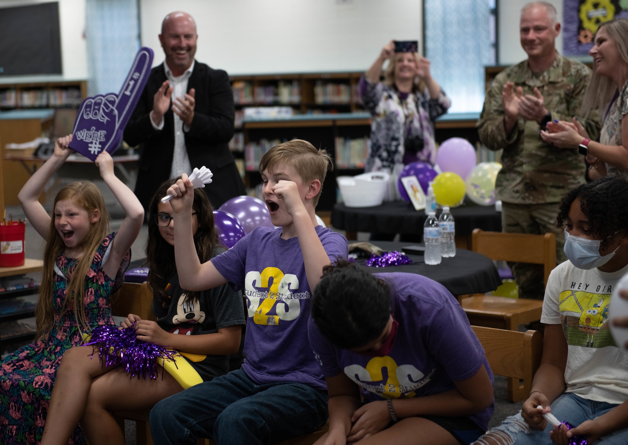 U.S. Air Force Col. Daniel Diehl, 509th Bomb Wing commander, celebrates the win of the Elite Team of the Year award with the Whiteman Elementary students and staff at Whiteman Air Force Base, Missouri, July 21, 2021. The Military Child Education Coalition® announced Whiteman Elementary as the winning school of the organization’s annual Student 2 Student® Team of the Year competition, which recognizes school teams' contribution assisting and integrating military students in their classrooms.
