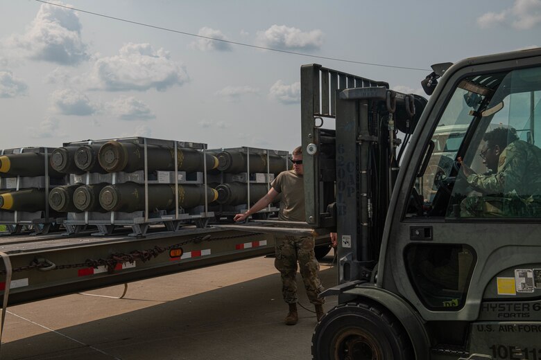 U.S. Air Force Airman Dylan Tyerman-Sterling, 509th Munitions Squadron munitions stockpile technician guides Airman 1st Class Isaiah Welch, 509th Munitions Squadron munitions stockpile technician, while unloading bomb bodies during exercise Quick Fuze at Whiteman Air Force Base, Missouri, July 20, 2021. Exercise Quick Fuze tests the munition squadron's ability to rapidly produce munitions to expeditiously arm every B-2 Spirit in the inventory.