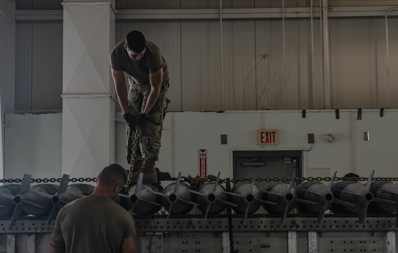 U.S. Air Force Tech. Sgt. Ryan Marler and Tech. Sgt. Jacob Moll, 131st Maintenance Squadron conventional maintenance crew chiefs, prepare live munitions for transport during exercise Quick Fuze at Whiteman Air Force Base, Missouri, July 20, 2021. Exercise Quick Fuze is designed to test the limits of the munitions teams by focusing on producing enough ammunition to fully arm every B-2 Spirit in the inventory.