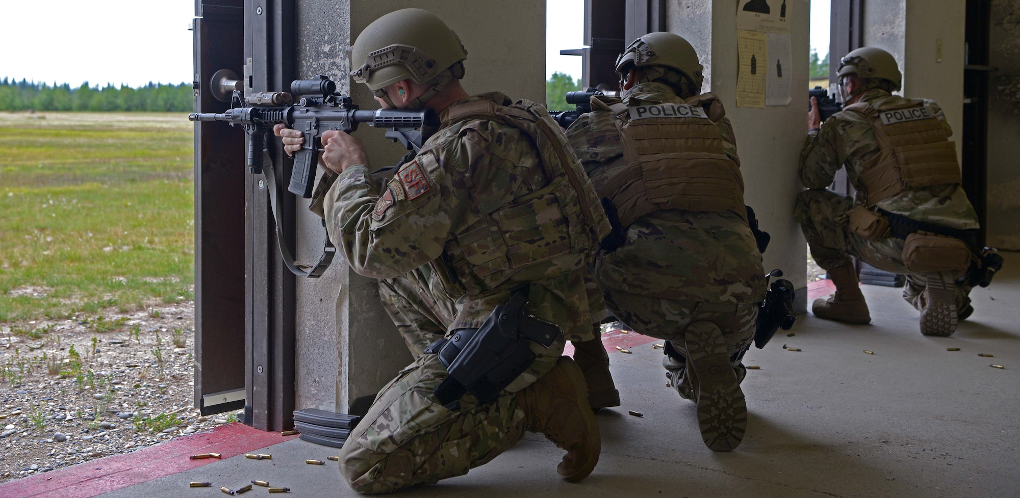 Airmen from the 354th Security Forces Squadron fire M4 carbines from the kneeling supported position during a new Security Forces Qualification Course on Eielson Air Force Base, Alaska, July 14, 2021. The new course will teach Defenders new firing positions and how to engage targets more tactically. (U.S. Air Force photo by Senior Airman Beaux Hebert)