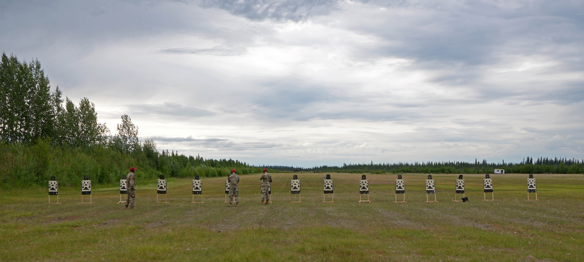 Airmen from the 354th Security Forces Combat Arms examine and score targets during a new Security Forces Qualification Course on Eielson Air Force Base, Alaska, July 14, 2021. Eielson is one of 15 installations testing the new weapons qualification course. (U.S. Air Force photo by Senior Airman Beaux Hebert)