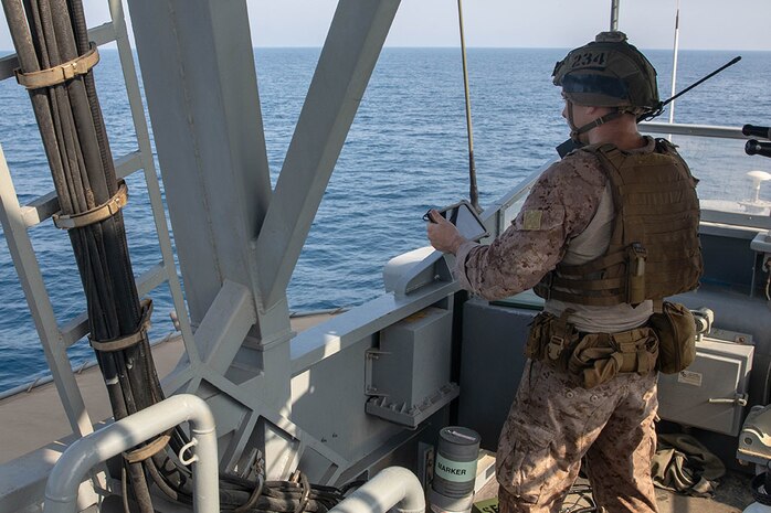 210721-A-UH336-0106 ARABIAN GULF (July 21, 2021) – Marine Cpl. Robert Van Pelt, observes targets aboard patrol coastal ship USS Tempest (PC 2) during a multilateral air operations in support of maritime surface warfare (AOMSW) exercise in the Arabian Gulf, July 21. Commander, Task Force 55 operates in the U.S. 5th Fleet area of operations in support of naval operations to ensure maritime stability and security in the Central Region, connecting the Mediterranean and Pacific through the western Indian Ocean and three critical chokepoints to the free flow of global commerce. (U.S. Army photo by Spc. Joseph DeLuco)