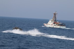 210721-N-N0146-1001 ARABIAN GULF (July 21, 2021) – Royal Navy and U.S. Navy Sailors operate a rigid hull inflatable boat with Coast Guard patrol boat USCGC Maui (WPB 1304) during a multilateral air operations in support of maritime surface warfare (AOMSW) exercise in the Arabian Gulf, July 21. Maui is deployed to the U.S. 5th Fleet area of operations in support of naval operations to ensure maritime stability and security in the Central Region, connecting the Mediterranean and Pacific through the western Indian Ocean and three strategic choke points. (U.S. Coast Guard photo by Petty Officer 2nd Class Joseph Perrone)