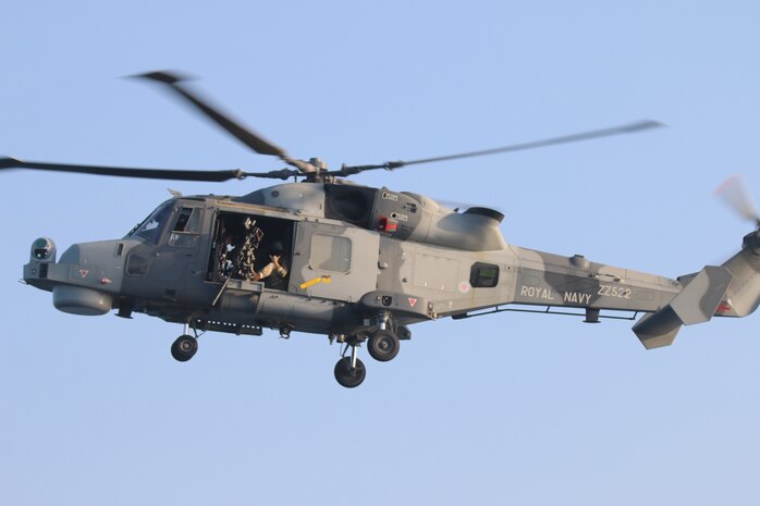 210721-N-N0146-1003 ARABIAN GULF (July 21, 2021) – A Royal Navy AW159 Wildcat helicopter conducts flight operations during a multilateral air operations in support of maritime surface warfare (AOMSW) exercise in the Arabian Gulf, July 21. (U.S. Coast Guard photo by Petty Officer 2nd Class Joseph Perrone)